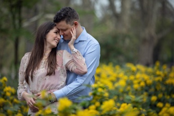 Engaged couple in yellow flowers