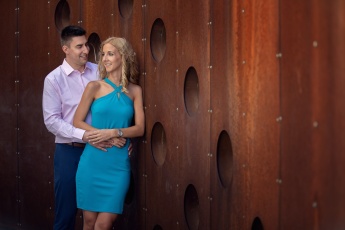 Elegant couple in front of metal background at a love session in Budapest