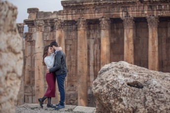 Engaged couple in front of columns at a photo shoot in Baalbek, Lebanon
