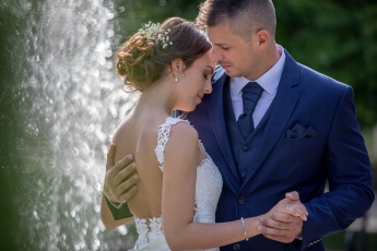 Bride and groom close-up with a fountain