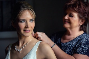 Bride and her mother with necklace